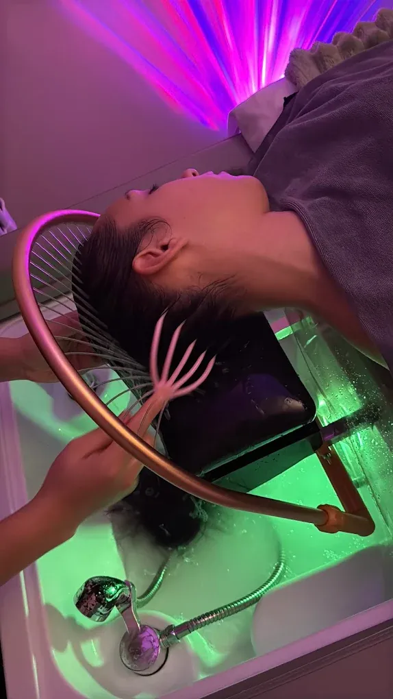 Warm-lit hydrotherapy arch above a head spa basin at Soul Massage Head Spa Everett
