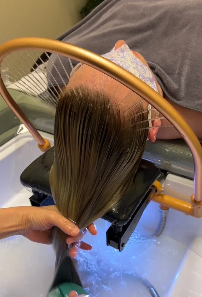 Therapist massaging a guest's scalp at a Soul hydrotherapy station