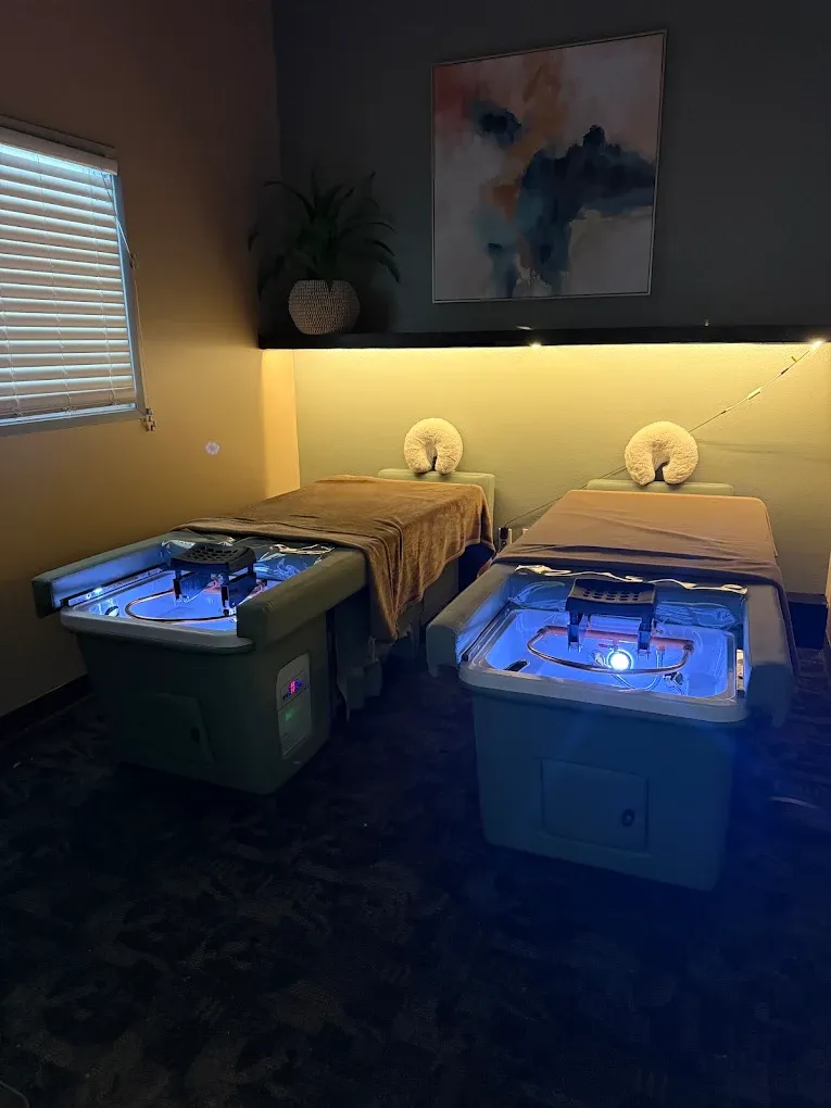 Couples room with two side-by-side massage tables and glowing hydrotherapy basins